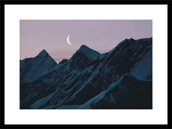 Moonrise over snowy mountains